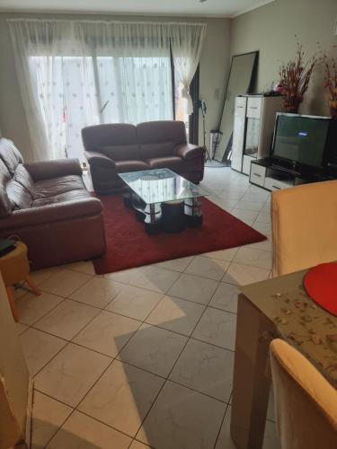 a living room with a couch and a coffee table at maison de vacances in Halle