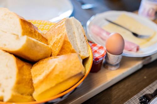 a tray of bread and eggs on a table at Chambres d'hôtes Maison Les Galettes in Rezay