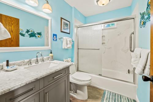 a bathroom with a sink and a toilet and a shower at All Decked Out in Cambria in Cambria