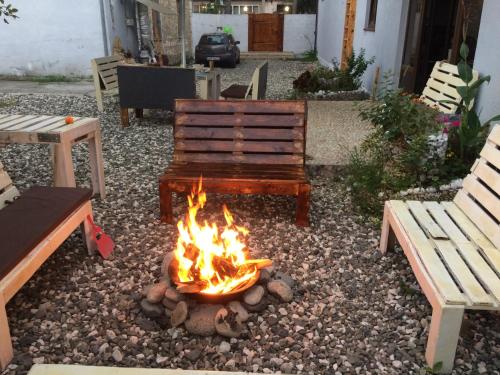 a fire pit in a yard with benches and a bench at Laura in Sukhum