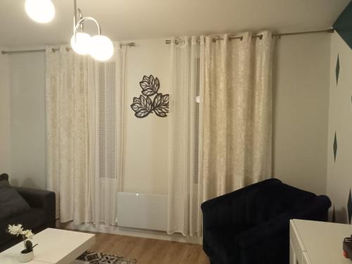 a living room with a window with a butterfly sticker on the wall at WIFI- STADE DE FRANCE- BASILIQUE CATHEDRALE MONSEJOURASAINTDENIS in Saint-Denis