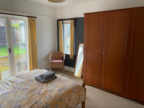 a bedroom with a bed and a cabinet and a chair at Green Bank in Hereford