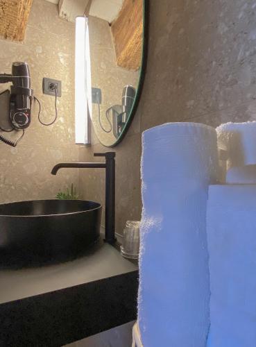 a bathroom with a sink and a mirror at Hotel Arimune in Bakio