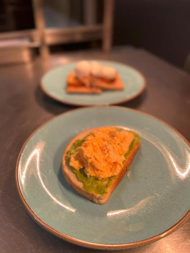 two plates with a piece of food on a table at Ravelston House in Musselburgh