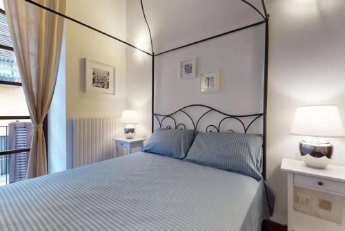a bedroom with a large bed and two lamps at Italianway - Borgospesso 14 in Milan