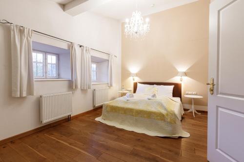 a bedroom with a bed and a chandelier at Seebacher Haus in Oberaudorf