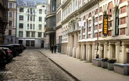 a cobblestone street in a city with buildings at Riga Center - Quiet Studio - 5 min to Old Town & NFLX in Rīga