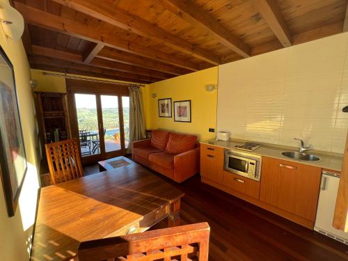 a kitchen with a table and a couch in a room at Apartamentos Monterodiles in Liñero