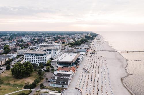 an aerial view of a beach with buildings and the water at aja Grömitz in Grömitz