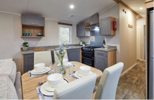 a kitchen and dining room with a table and chairs at Seaton Estate in Arbroath