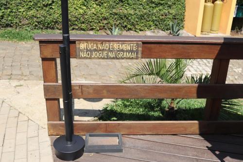 a wooden bench with a sign that reads buffalo wood exchange who declined pumpkin at Paraíso do Salto in Lages