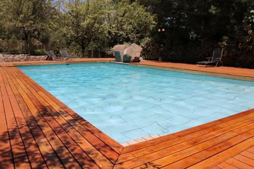 a large swimming pool with a wooden deck at La Petite France in San José de Maipo