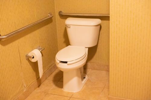 a bathroom with a toilet and a roll of toilet paper at Colfax Inn By Marifah in Colfax