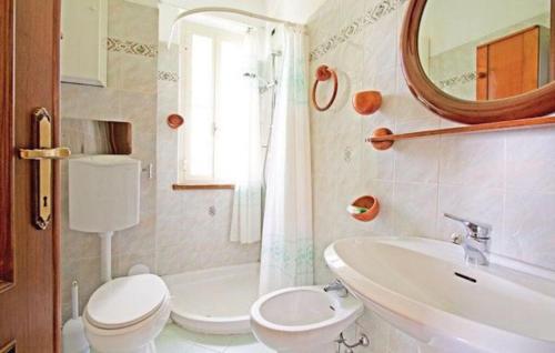 La salle de bains est pourvue de toilettes, d'un lavabo et d'un miroir. dans l'établissement Villa Las Palmas by Nicola Real Estate, à Corsanico-Bargecchia