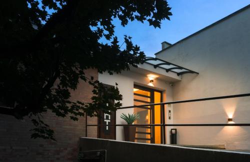 a house with lights on the side of it at TURINHOMETOWN Residence Apartments in Turin