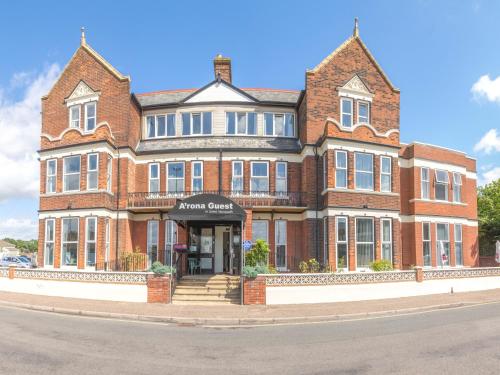 a large brick building on the corner of a street at Arona Guest Hotel in Great Yarmouth
