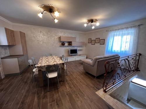 a living room with a table and a couch at Da Nonna Maria in Celano