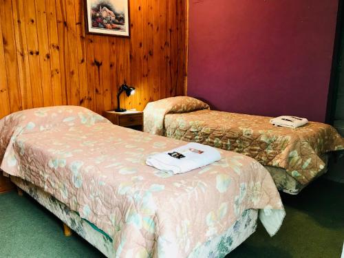 Cama o camas de una habitación en Amancay, Hostal Patagonico