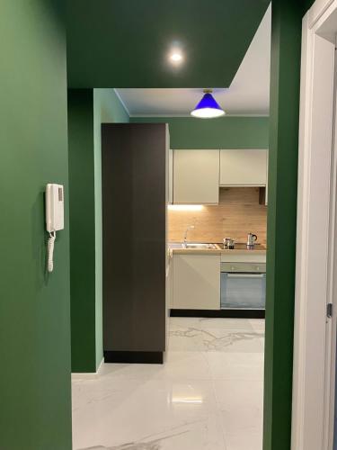 A kitchen or kitchenette at DIZETA Suite and Apartment