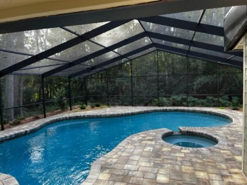 an overhead swimming pool with a black pergola at Gator Pool and Hot Tub House -1.5 miles to Stadium in Gainesville