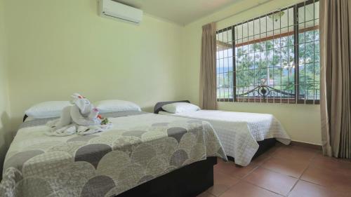 a bedroom with two beds and a stuffed elephant on the bed at Condo's Vista Al Volcan in Fortuna