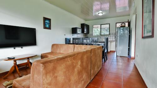 a living room with a couch and a flat screen tv at Condo's Vista Al Volcan in Fortuna