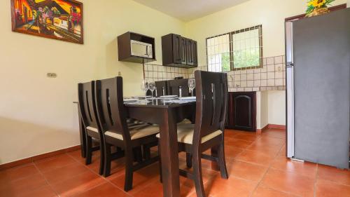 a kitchen with a table with chairs and a microwave at Condo's Vista Al Volcan in Fortuna