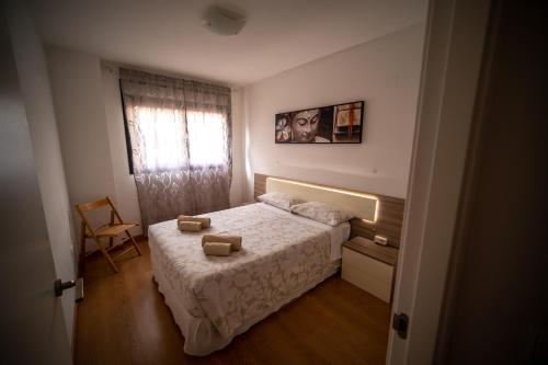 a small bedroom with a bed and a window at Orillas del Castillo in Alicante