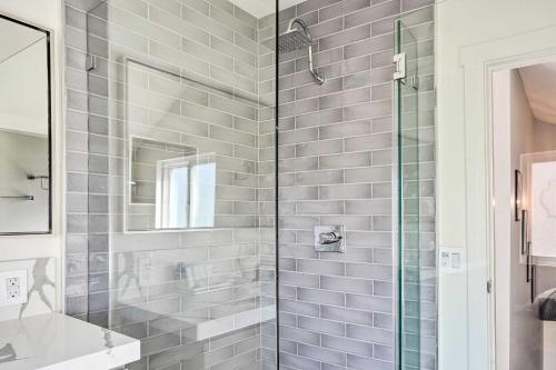 a bathroom with a shower with a glass door at Luxe Laguna Home with Ocean View Walk to Beach in Laguna Beach