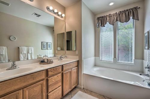 a bathroom with a tub and a sink at Goodyear Desert Oasis Walk to Community Pool in Goodyear