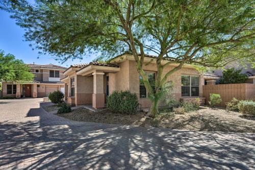 a house with a tree in front of a driveway at Walk to Community Pool Goodyear Desert Oasis in Goodyear