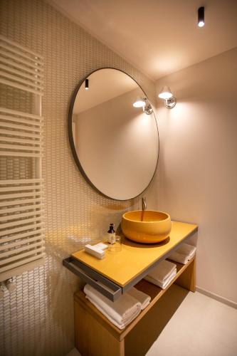 a bathroom with a sink and a mirror at Villaggio Narrante - Cascina Galarej in Serralunga d'Alba