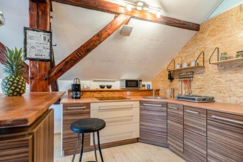 a kitchen with a counter and a stool in it at LTE Apartments in Maribor