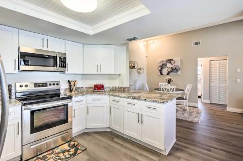a kitchen with white cabinets and a counter top at Waterfront Port Richey House with Heated Pool! in Port Richey