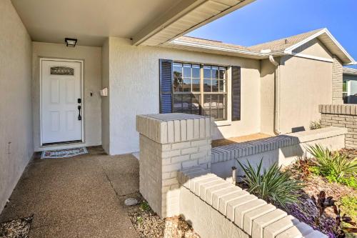 a white house with a door and a window at Waterfront Port Richey House with Heated Pool! in Port Richey