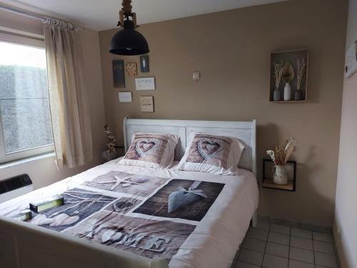 a bedroom with a bed with a poster of two anchors at The Beach House in Middelkerke