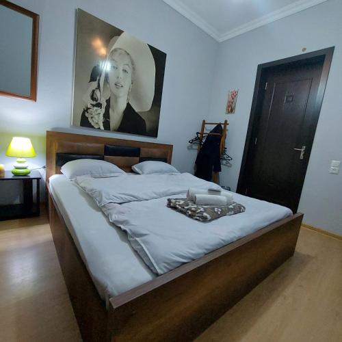 a bedroom with a bed with a tray of food on it at Guesthouse different in Tbilisi City