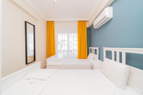 a white room with two beds and a window at Flat with Balcony and Shared Pool in Belek in Belek