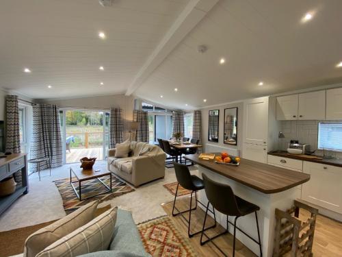 a kitchen and living room with a table and chairs at Holicarrs - Gingerlily in Riccall