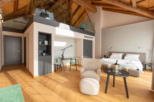a bedroom with a bed and a table and a chair at Villaggio Narrante - Cascina Galarej in Serralunga d'Alba