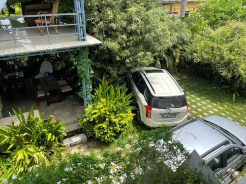 a car parked in the yard of a house at Rain Homestay in Alleppey