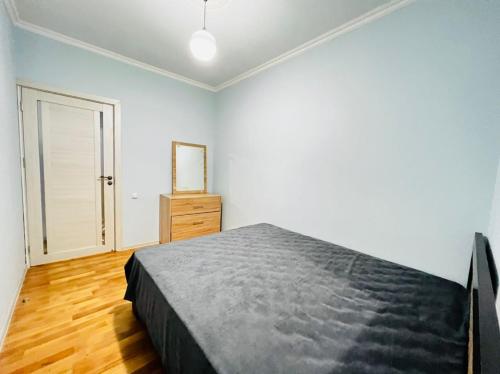 a bedroom with a bed and a dresser in it at Modern Elegant Renovated Apartment, New Building, Chekhov stree in Yerevan