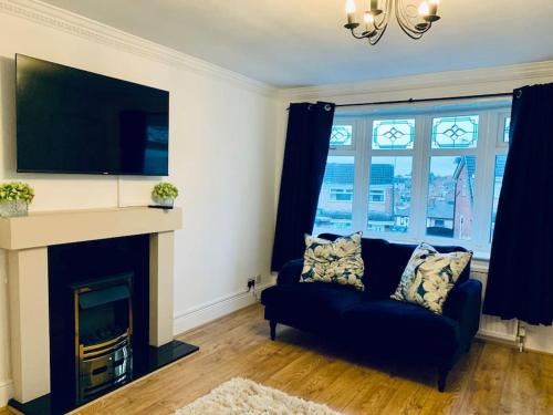 a living room with a couch and a fireplace at Homely Detached 3 bedroom house near Sheffield in Rotherham