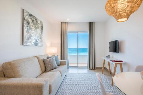 a living room with a couch and a table at Clube Porto Mos - Sunplace Hotels & Beach Resort in Lagos