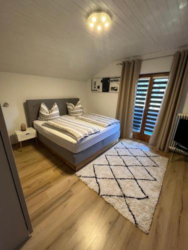 a bedroom with a bed and a rug at Haus Knauß in Schladming