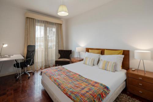 a bedroom with a bed and a desk and a chair at Casa Sta Clara by An Island Apart in Funchal