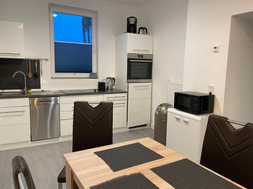 a kitchen with a table and a microwave at MR Ferienwohnung - Wohnung Mila 