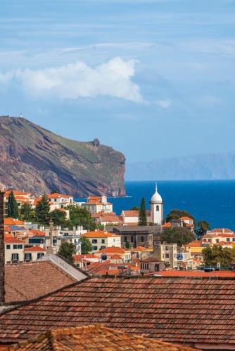 a view of a town with the ocean in the background at Casa Sta Clara by An Island Apart in Funchal