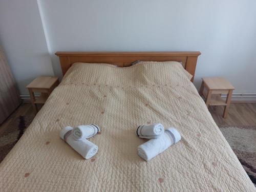 two rolls of toilet paper on a bed at Apartman Centar in Sremska Mitrovica