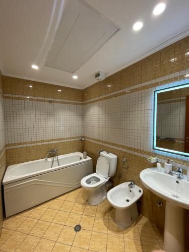 łazienka z wanną, toaletą i umywalką w obiekcie Middle Center Gallery 1 Skanderbeg Square w Tiranie
